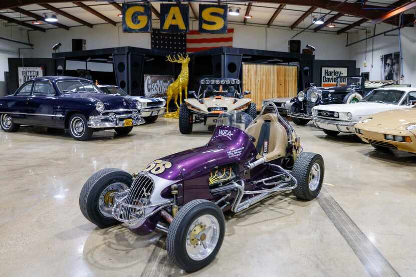 A Kurtis racer (center) is among the 25 hot rods Richard Rawlings is selling starting...