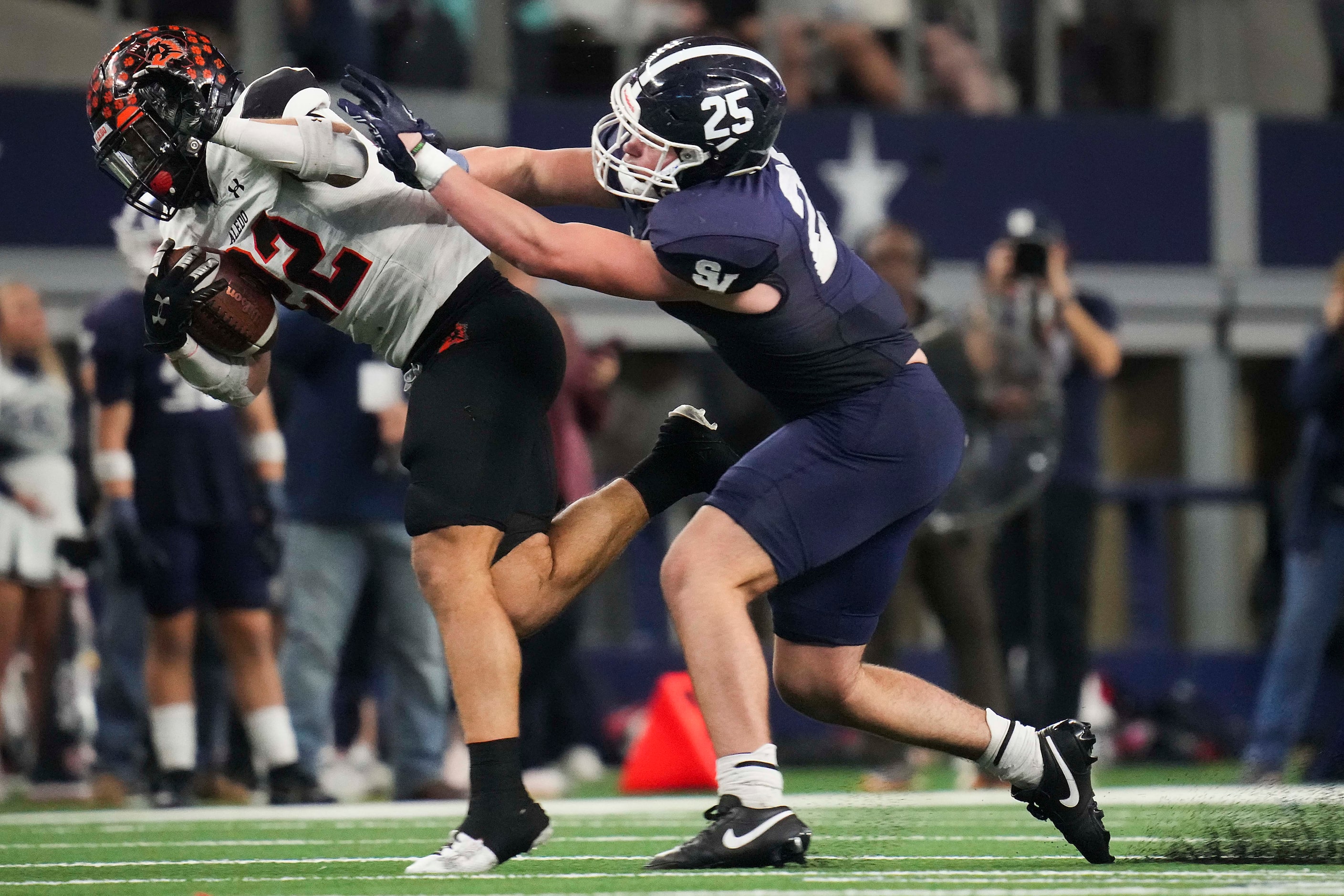 Aledo Chase Wilburn (32) is brought down by Comal Smithson Valley linebacker Jaxson Maynard...