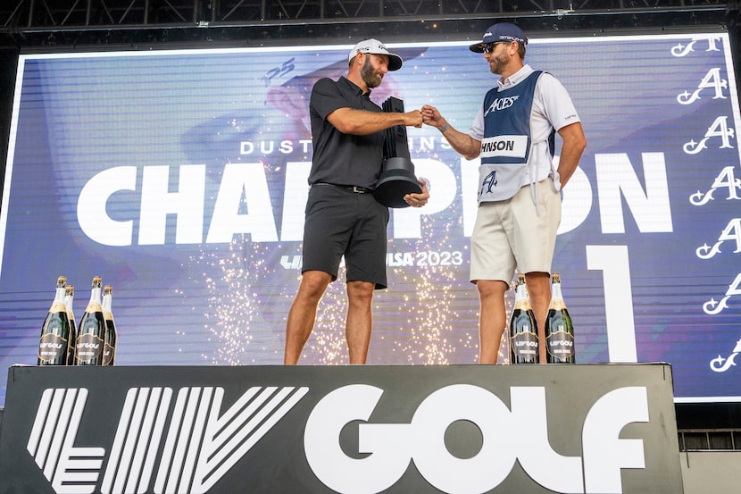 In May, golfer Dustin Johnson (left) and his caddy Austin Johnson celebrated during a trophy...