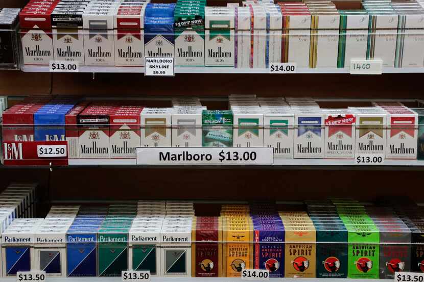 FILE- In this March 18, 2013 file photo, cigarette packs are displayed at a convenience...