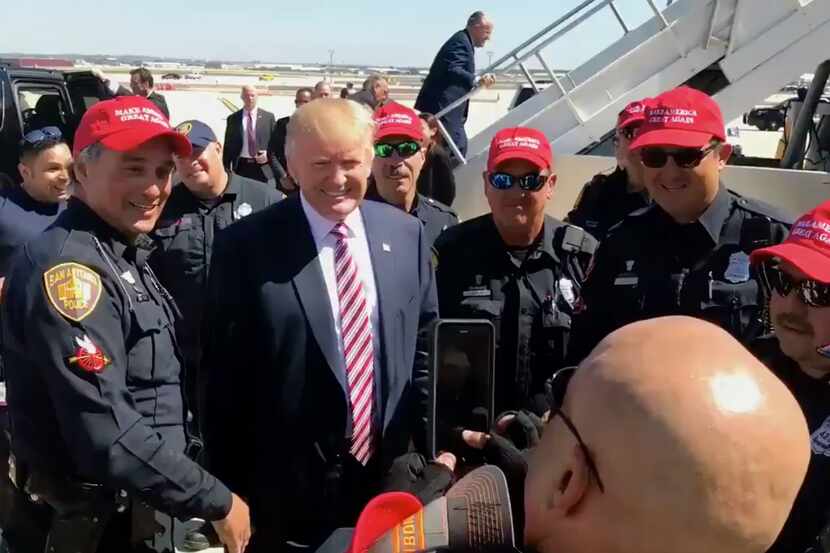 San Antonio police officers pose with Donald Trump after his campaign fundraiser on Tuesday....