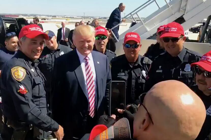 San Antonio police officers posed with Donald Trump after his campaign fundraiser Tuesday....