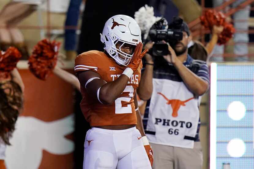Texas running back Roschon Johnson (2) celebrates his touchdown against UTSA during the...