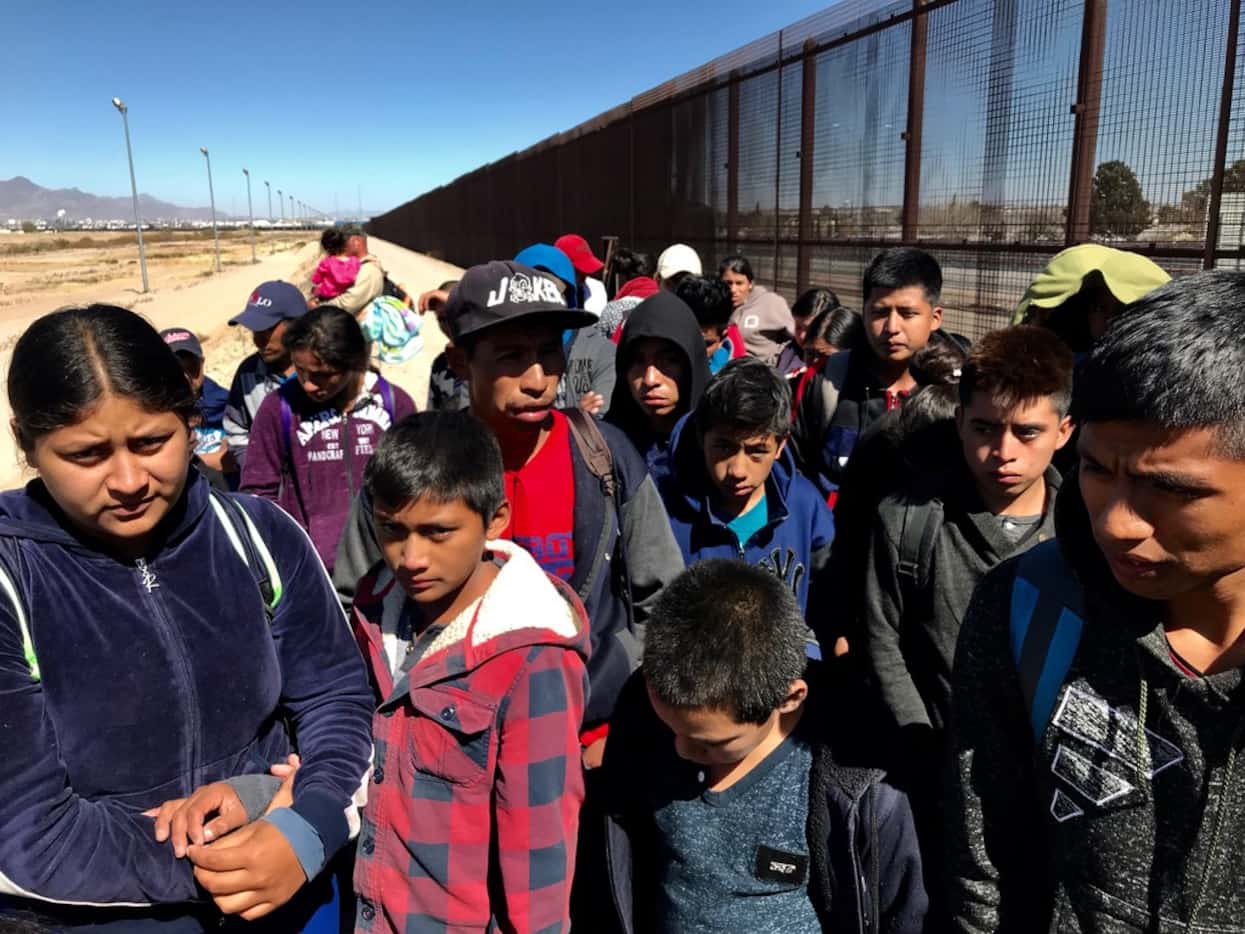 Migrants who crossed the border and turned themselves in to the border patrol were being...