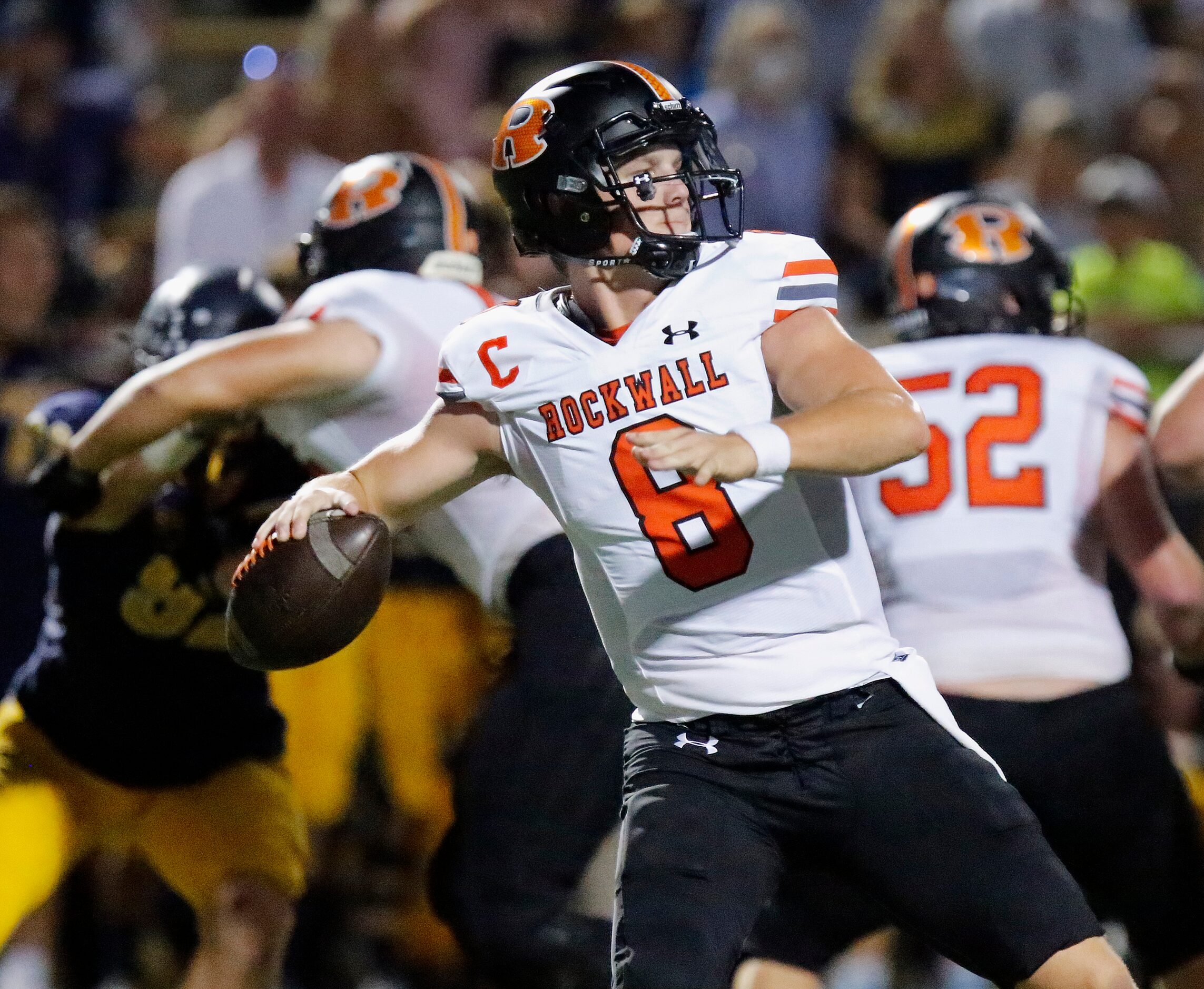 Rockwall High School quarterback Braedyn Locke (8) throws a pass during the first half as...