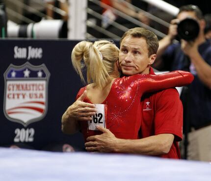 Nastia Liukin gets a hug from her father and coach Valeri Liukin after competing in the beam...