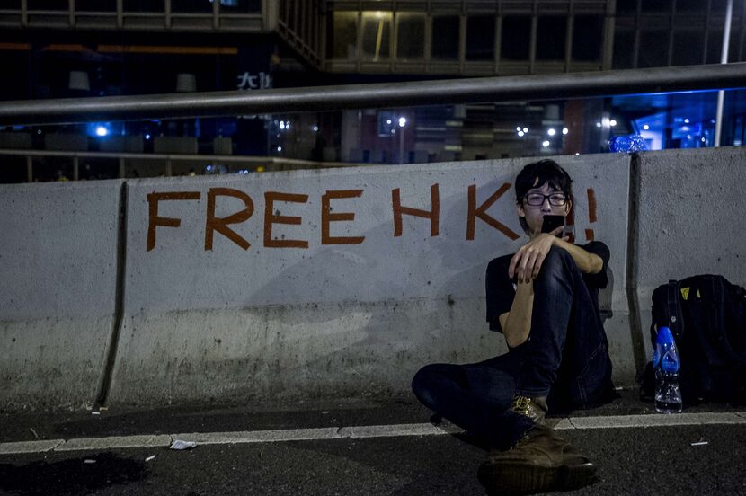 A protester rests following pro-democracy protests in Hong Kong on September 29, 2014. ...