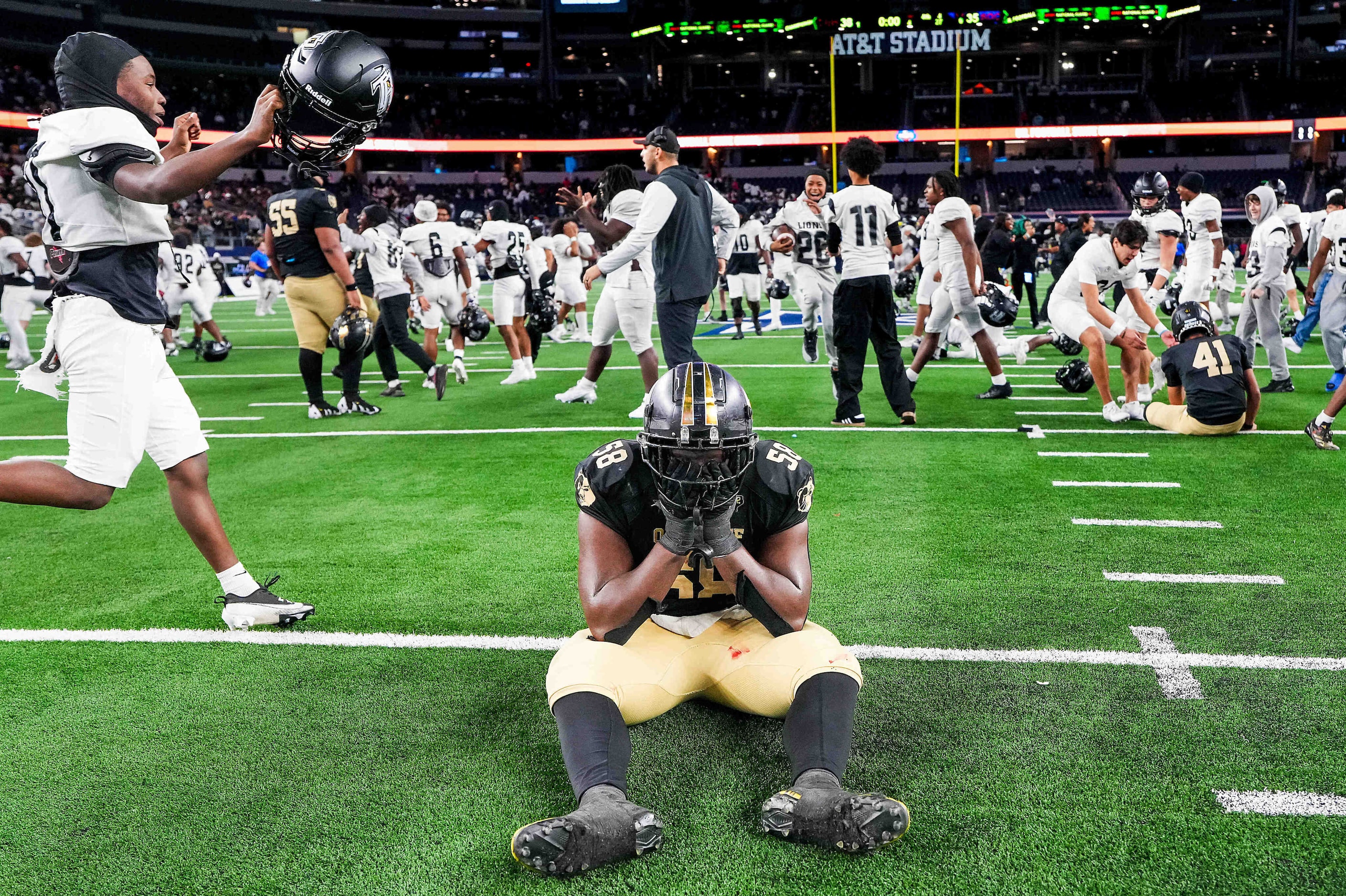 South Oak Cliff offensive lineman Byron Abner (58) reacts as Richmond Randle players...