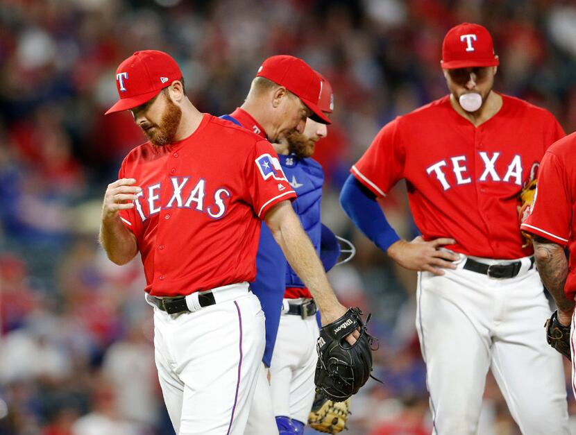 FILE - Sam Dyson (left) leaves the mound after Rangers manager Jeff Banister pulled him in...