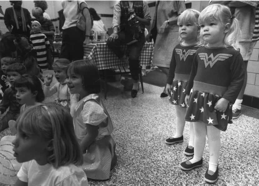 Two-year-old twins Caroline and Margaret Rebensdorf watch a clown show while attending the...