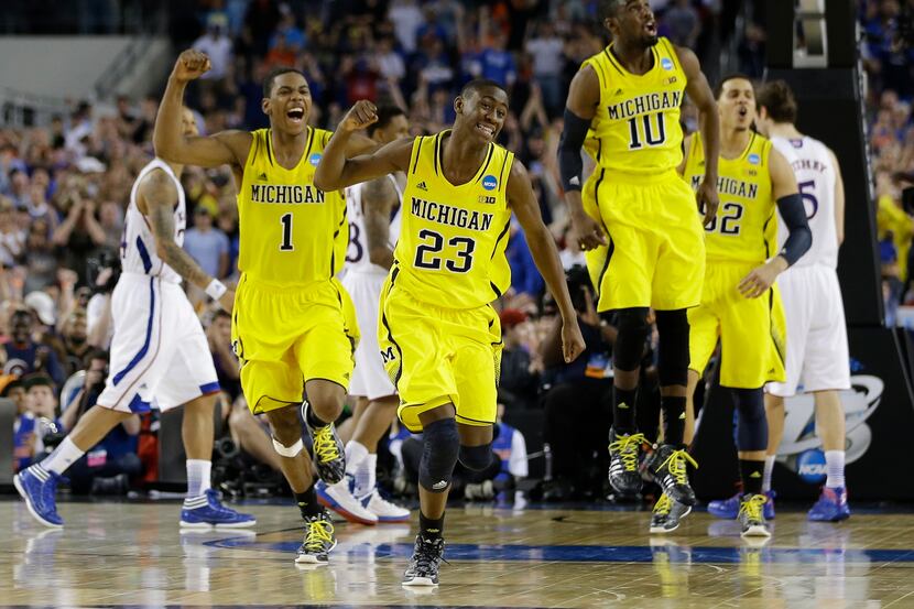 Michigan celebrates after beating Kansas  87-85 in overtime of a regional semifinal game in...