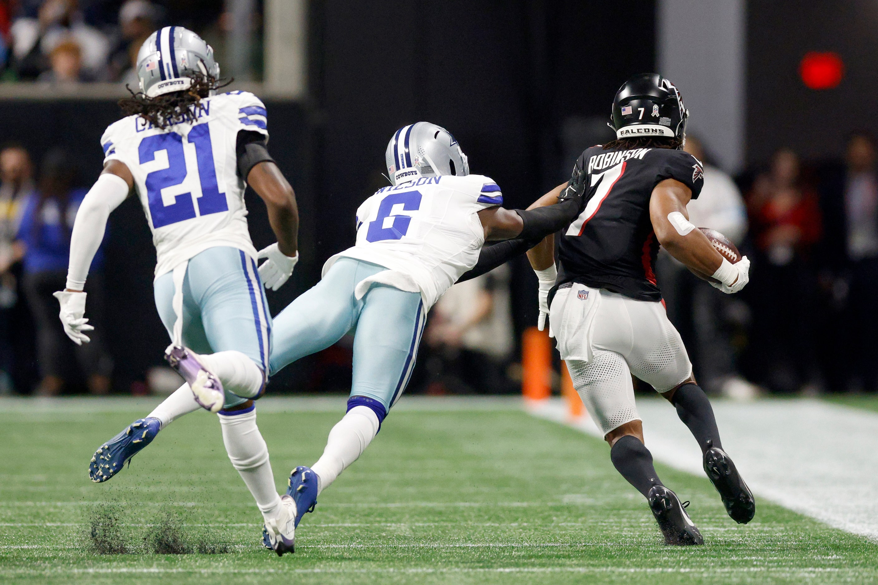 Dallas Cowboys safety Donovan Wilson (6) pushes Atlanta Falcons running back Bijan Robinson...