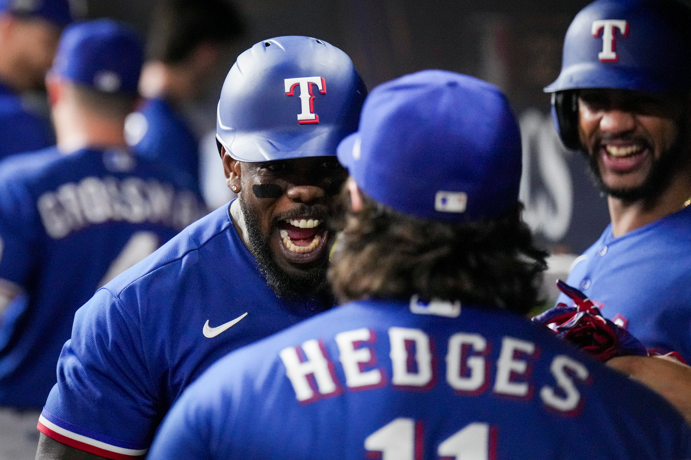 Texas Rangers right fielder Adolis Garcia (53) celebrates in the dugout with catcher Austin...