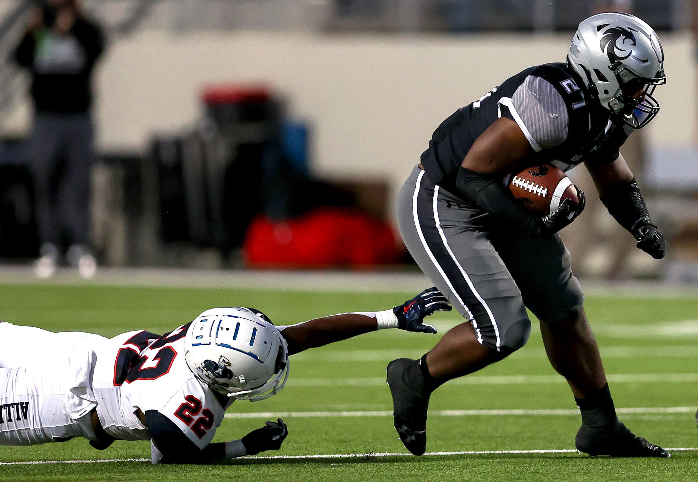 Denton Guyer running back Byron Phillips (27) gets past Allen defensive back Michael Momoh...