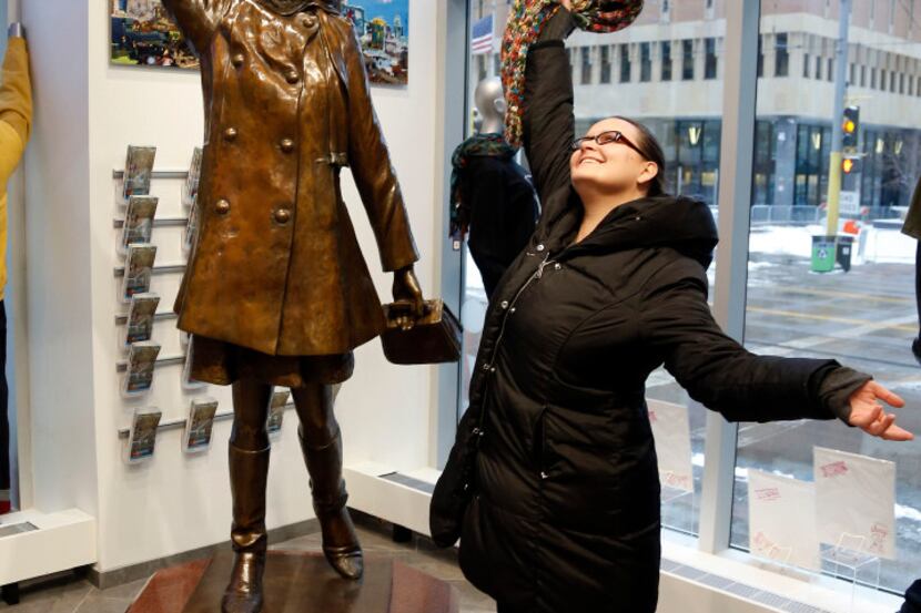 A fan who wanted to remain anonymous strikes a pose by the life-size bronze statue of Mary...