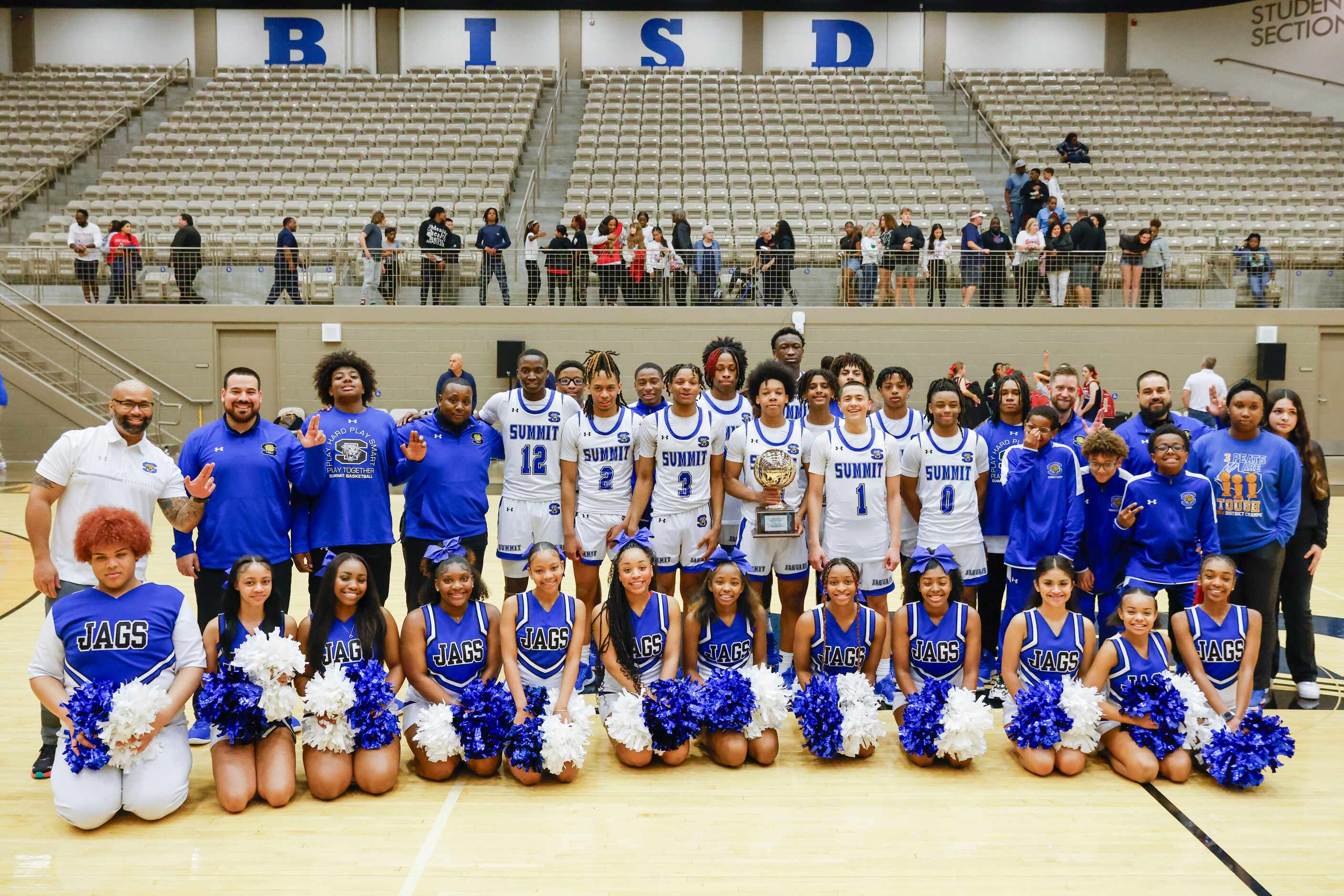 Mansfield Summit High players pose for a celebratory photo following their victory against...