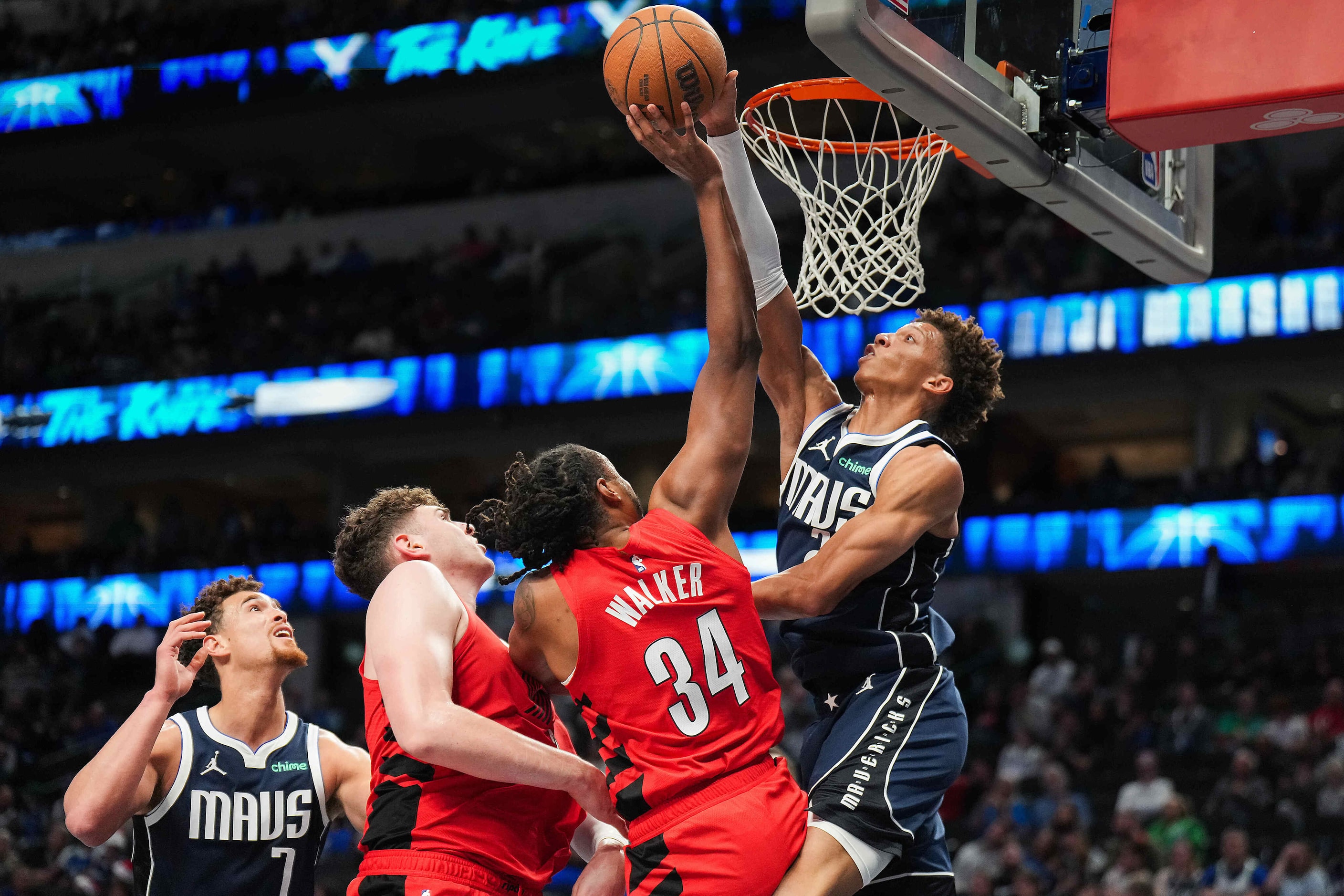 Dallas Mavericks forward Kessler Edwards (20) blocks a shot by Portland Trail Blazers...