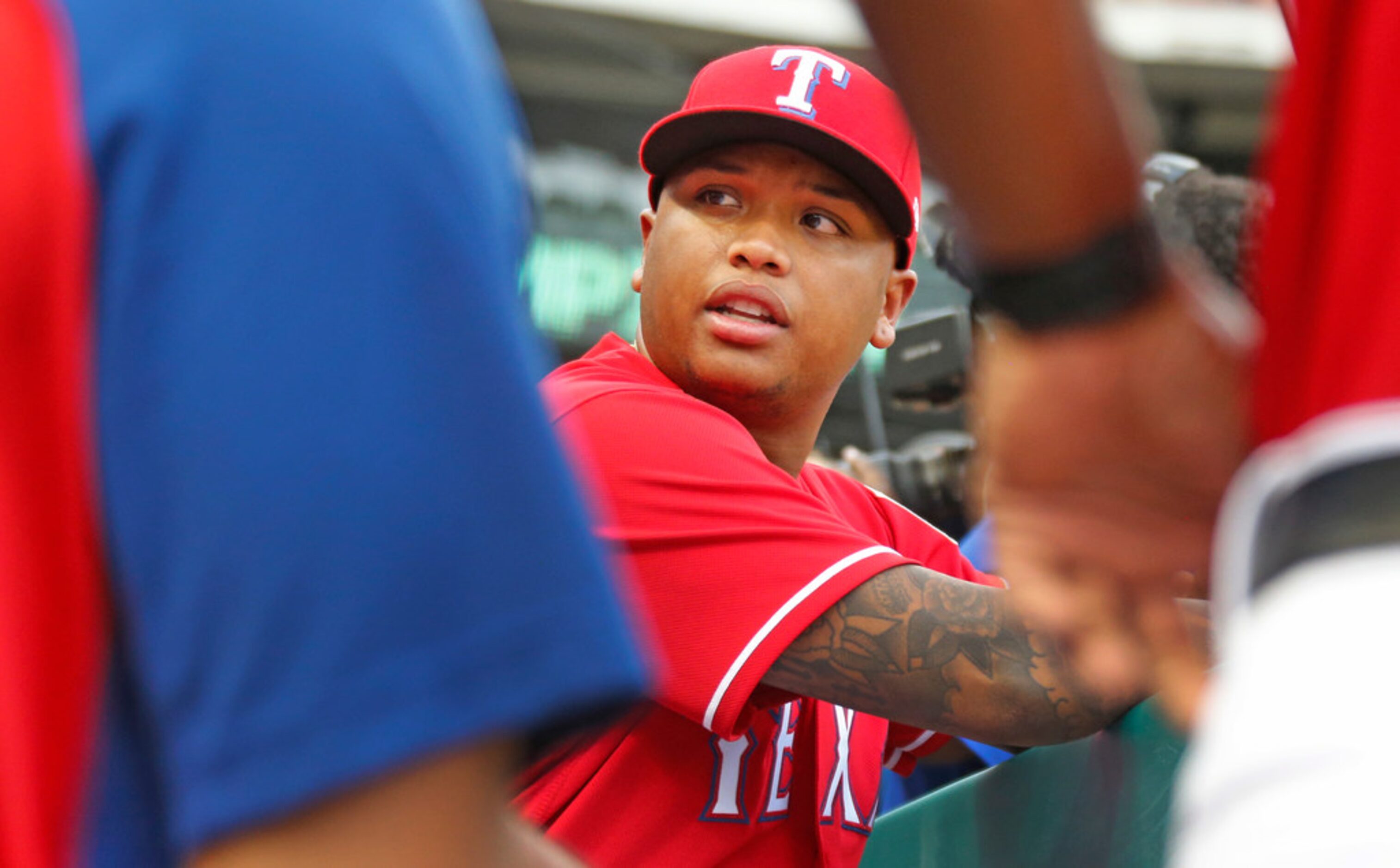 Texas Rangers designated hitter Willie Calhoun (5) is pictured in the dugout before the...