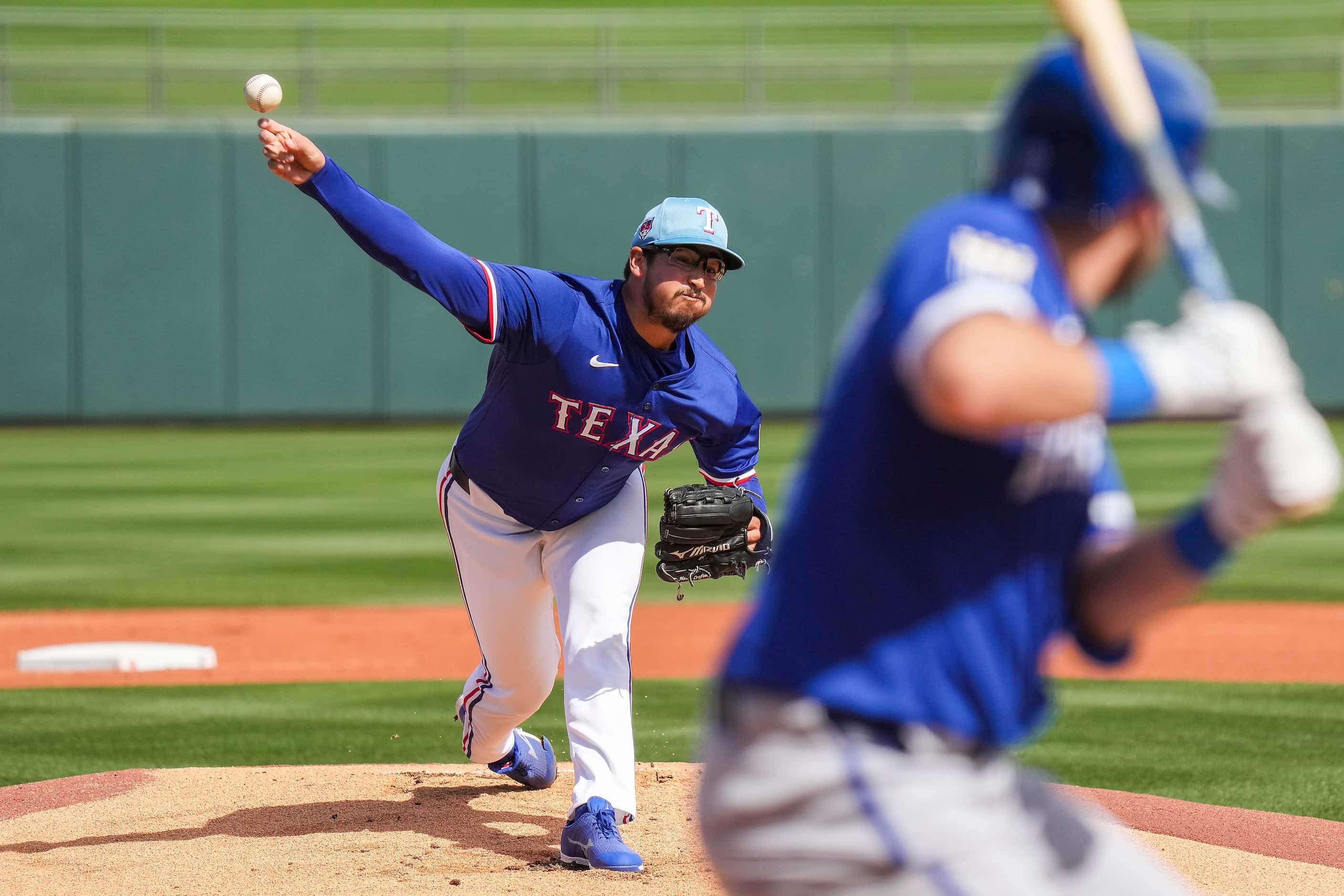Texas Rangers pitcher Dane Dunning delivers  during the first inning of a spring training...
