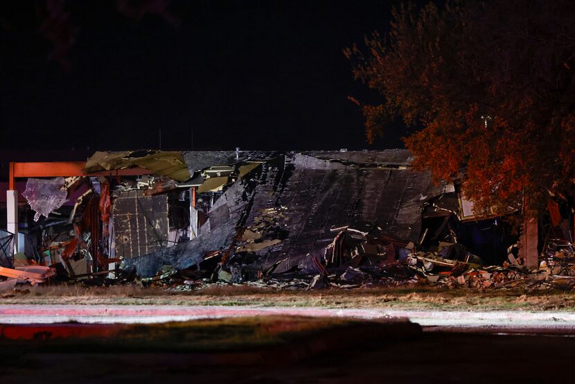 A building is seen partially demolished as Dallas Fire-Rescue works the scene of a fire at...