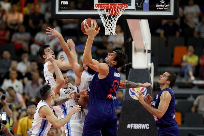 Serbia's Boban Marjanovic secures the ball from Argentina's players during a quarterfinal...