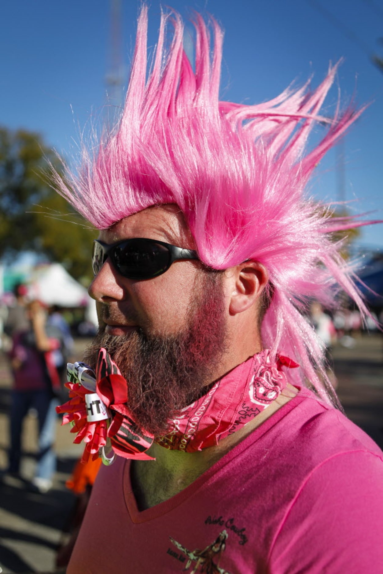 Wayne Richardson of Kennedale, Texas greets walkers at the finish line of the 2014 Susan G....