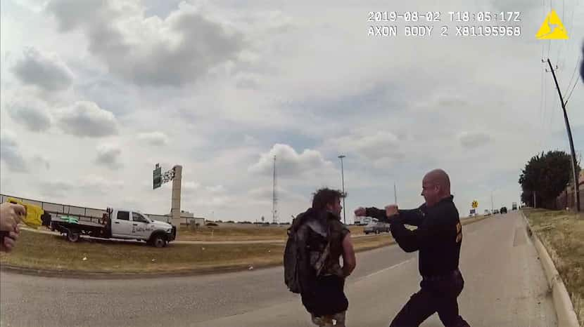 A frame from a police body cam shows Dallas firefighter Brad Cox during an altercation with...