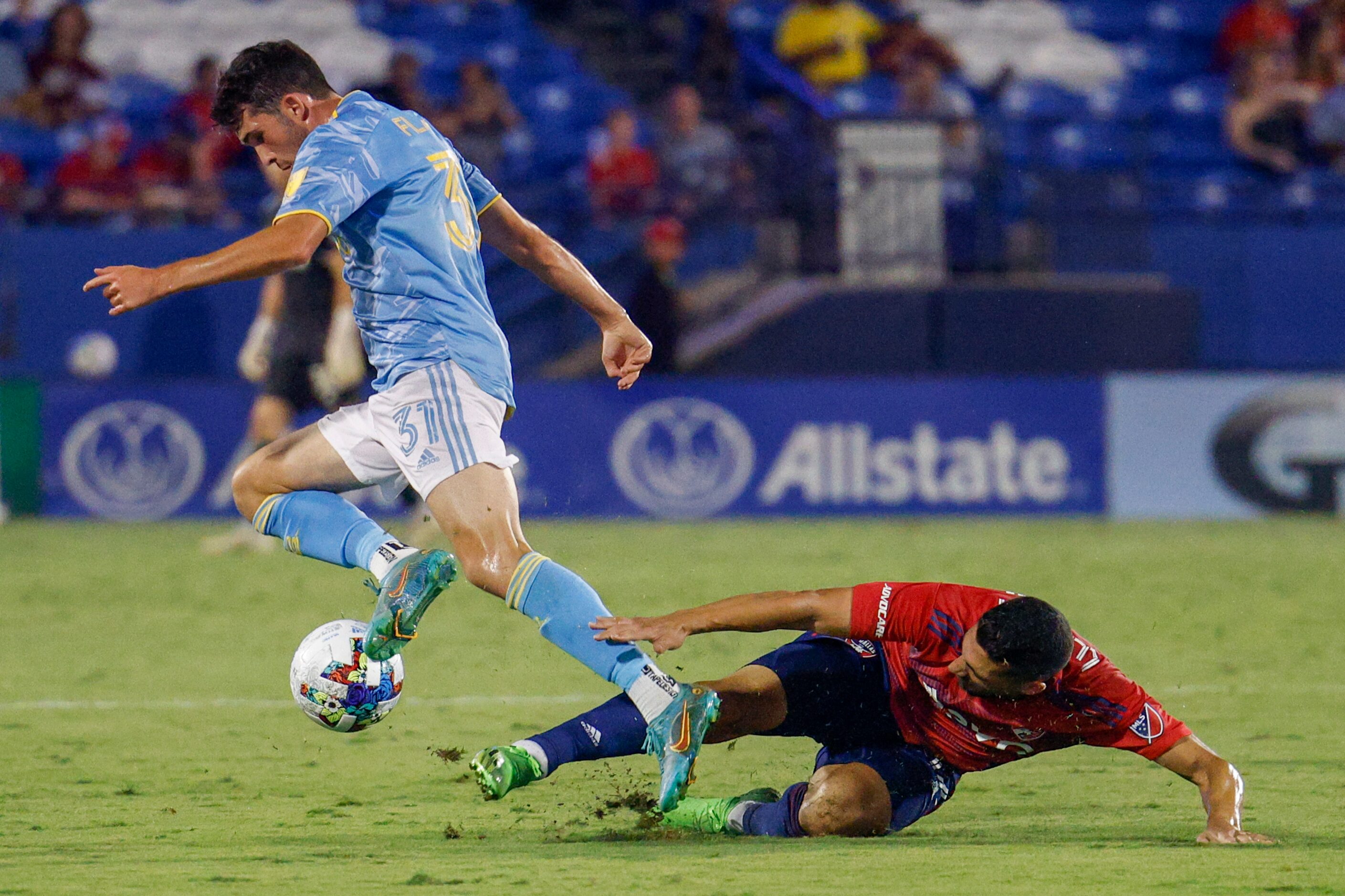 FC Dallas midfielder Sebastian Lletget (12) attempts a slide tackle on Philadelphia Union...