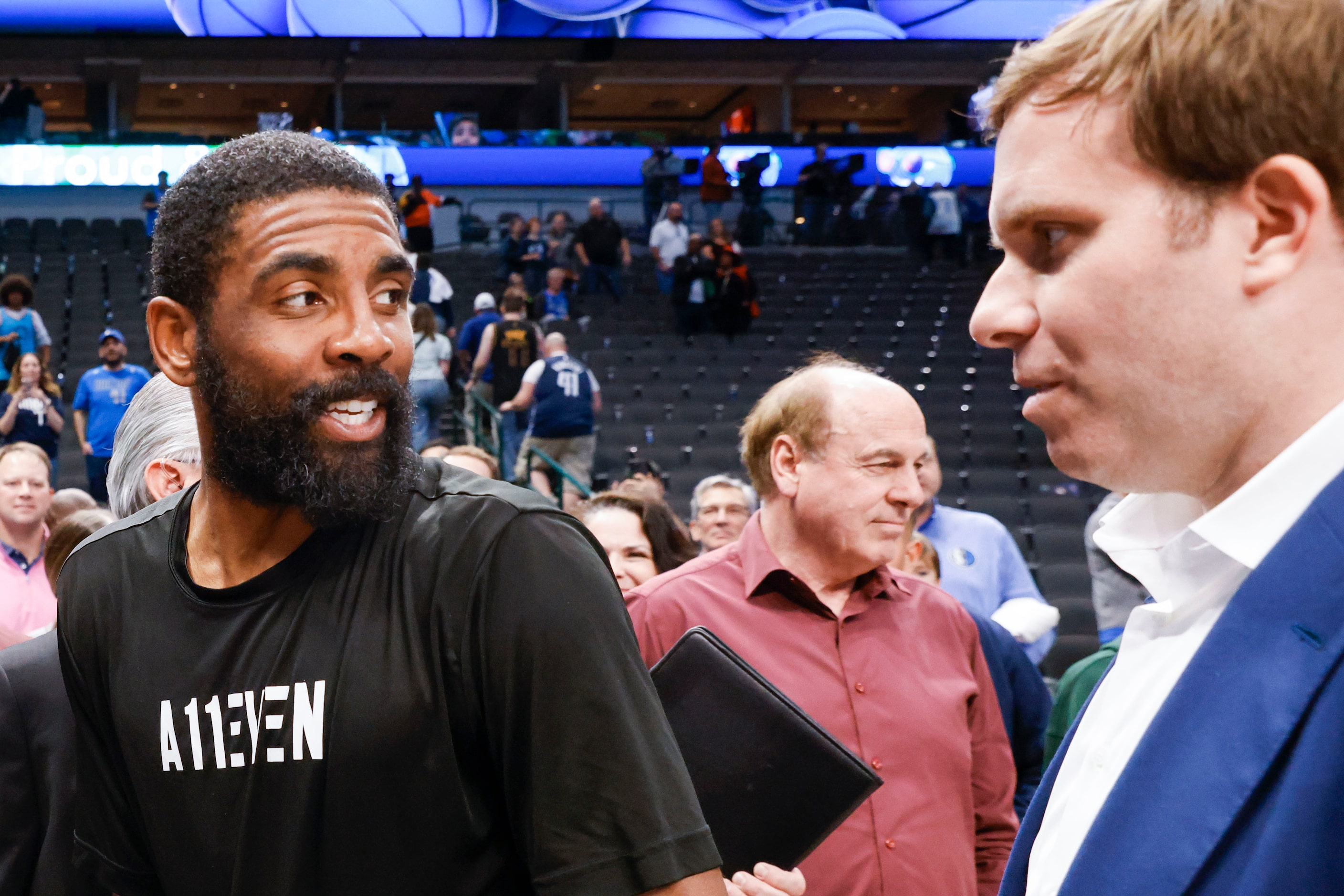 Dallas Mavericks guard Kyrie Irving (left) talks to Dallas Mavericks Governor Patrick Dumont...