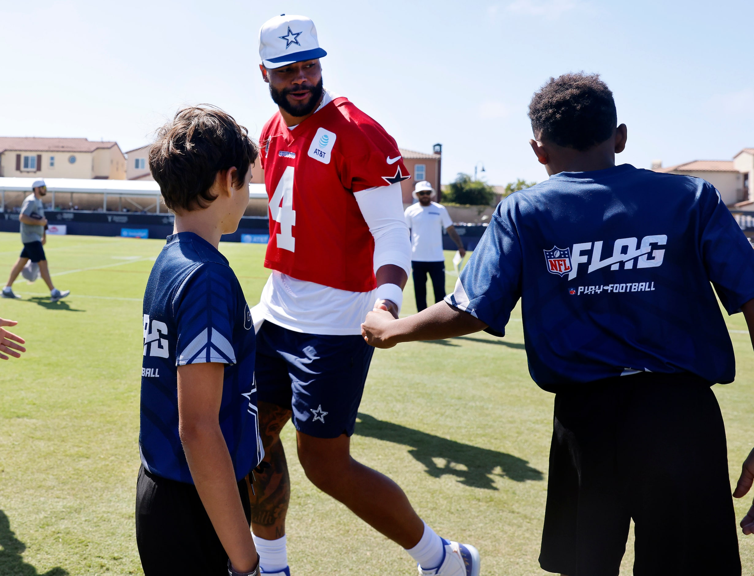 Youth NFL Flag Football players from Ventura County slap hands with Dallas Cowboys players,...