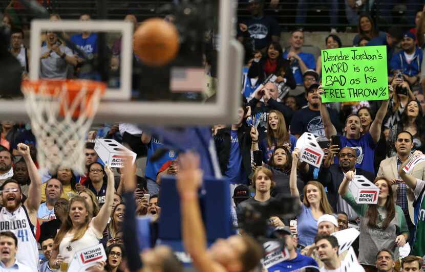 Dallas Mavericks fan holds up a sign as Los Angeles Clippers center DeAndre Jordan (6)...