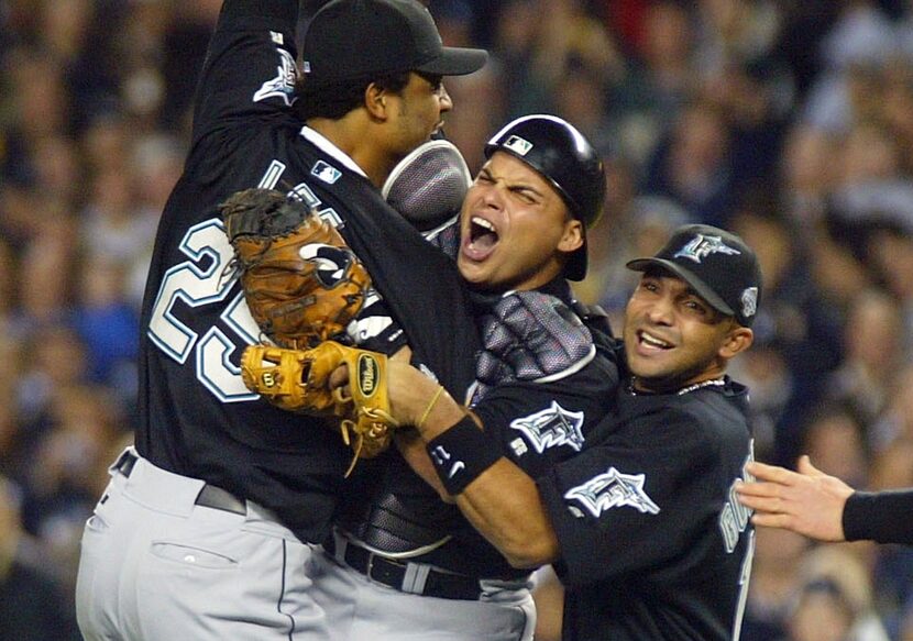 BRONX, NY - OCTOBER 25: Ivan Rodriguez #7 of the Florida Marlins celebrates with teammates...