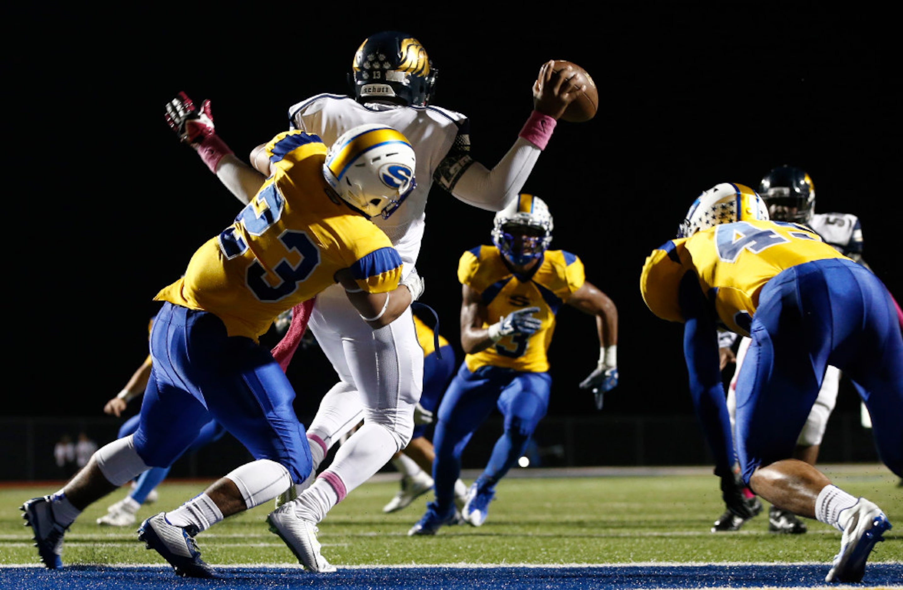 Life Oak Cliff quarterback Chayce Harris is hit by Sunnyvale linebacker Kyle Garza (23) has...