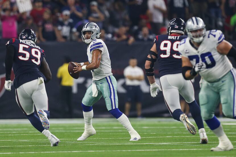 FILE - Cowboys quarterback Dak Prescott (4) looks to throw during the first quarter of a...