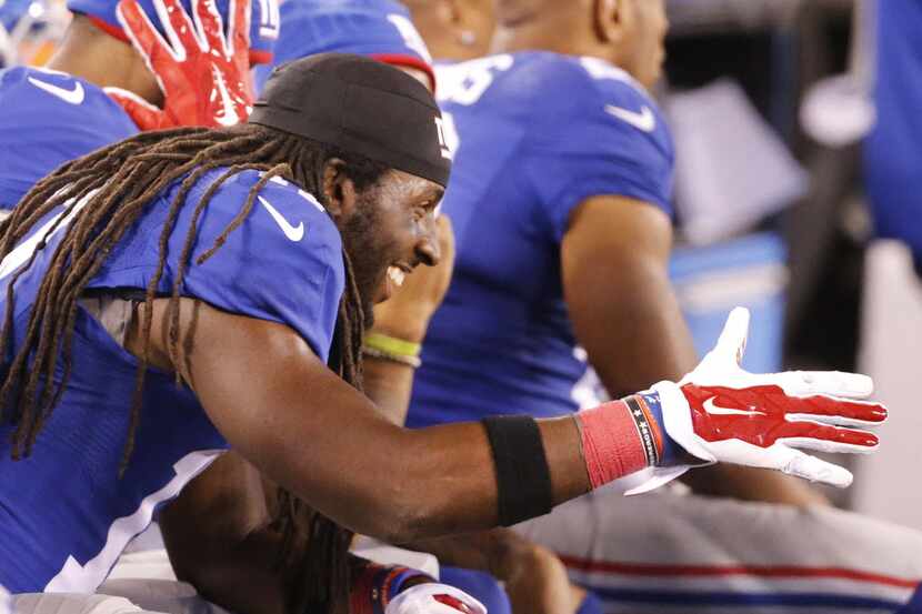 New York Giants wide receiver Dwayne Harris (17) is all smiles on the Giants bench after...