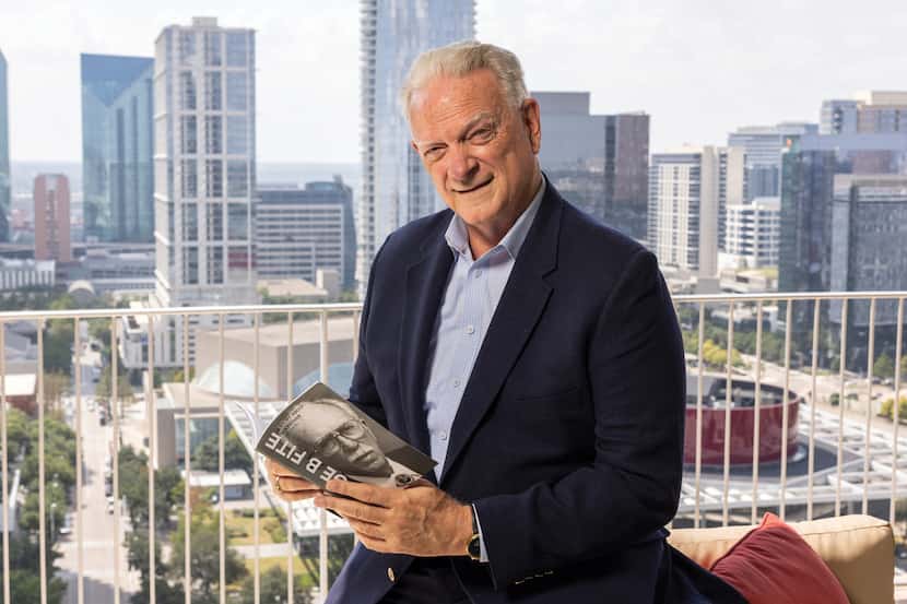President and CEO of Century 21 Jim Fite pictured holding the book he wrote, with the Dallas...