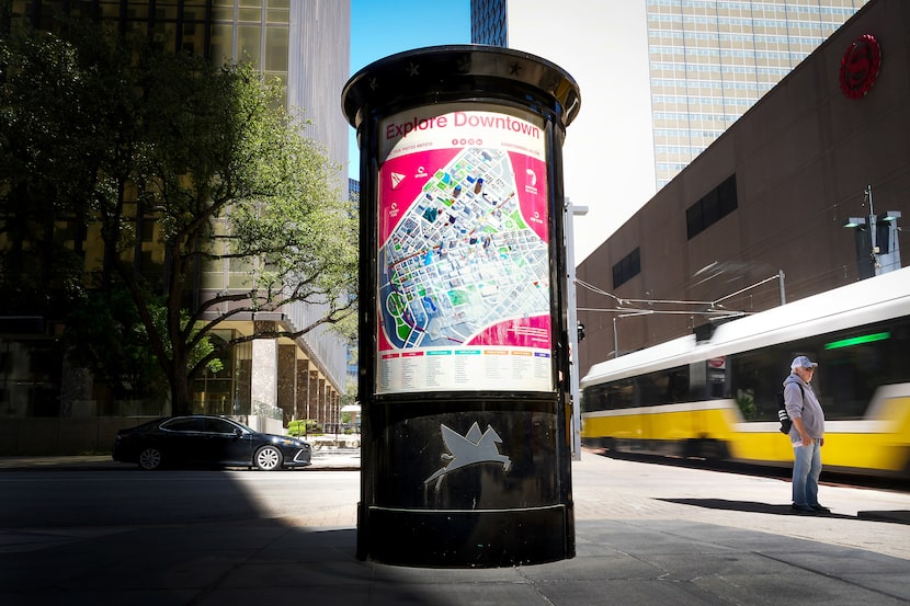 A pedestrian waited near a kiosk with an area map on it at DART's St. Paul Station in...