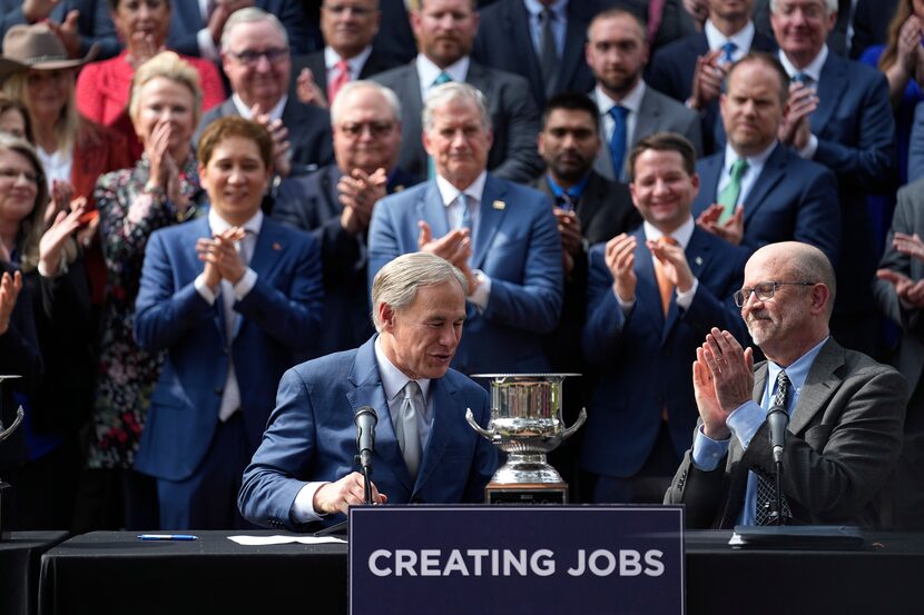 Texas Gov. Greg Abbott (front left) reacted after he and the Texas Legislature were awarded...