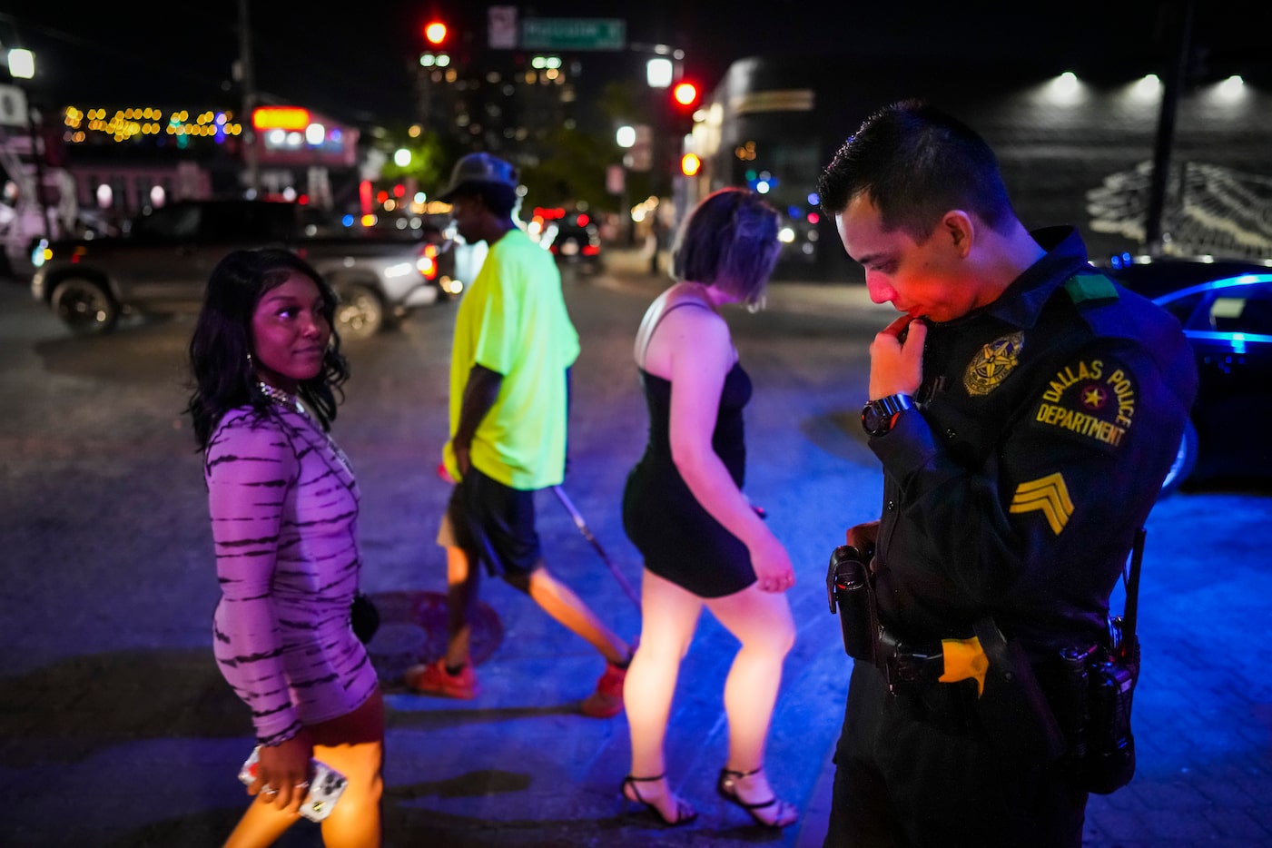 Dallas police Sgt. Boz Rojas talks on his radio as he prepares to give the order to close...