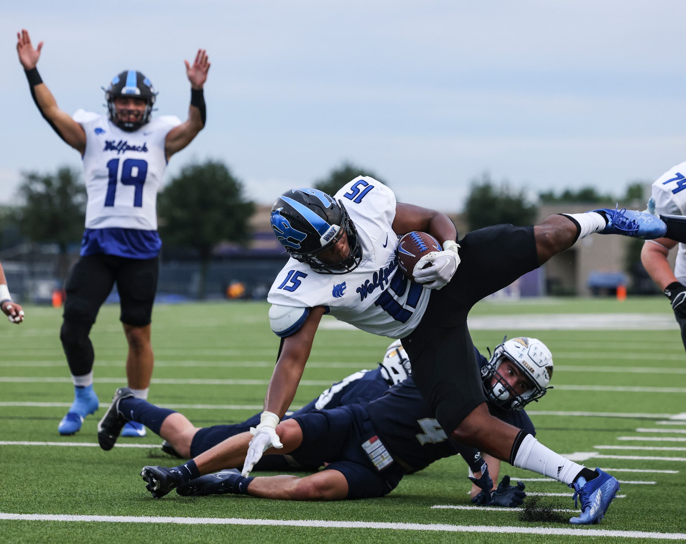 Plano West Senior High Demetrius Willis (15) dives into the end zone to score the first...