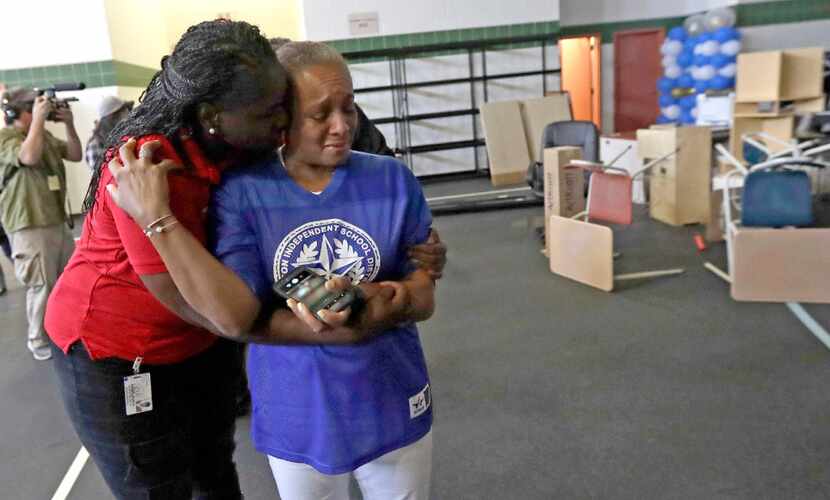 Houston ISD Board of Education Trustee Rhonda Skillern-Jones(right) is hugged by board...