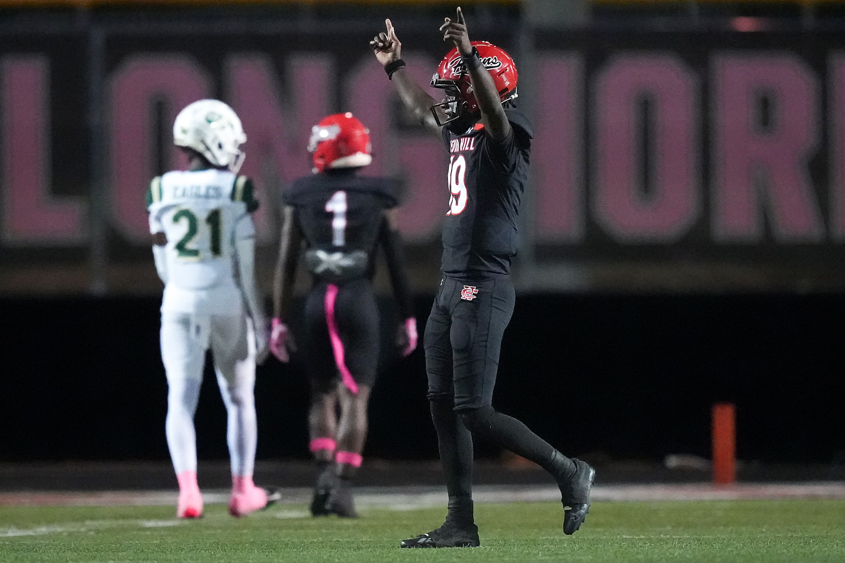 Cedar Hill quarterback Omowale Muhammid (19) celebrates after a touchdown run by running...