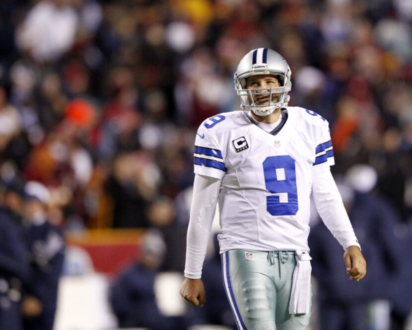 Dallas Cowboys quarterback Tony Romo (9) makes his way back to the field during a break in...