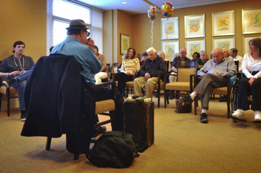 Vincent Van Buren plays harmonica to a full room at The Legacy at Willow Bend in Plano for...
