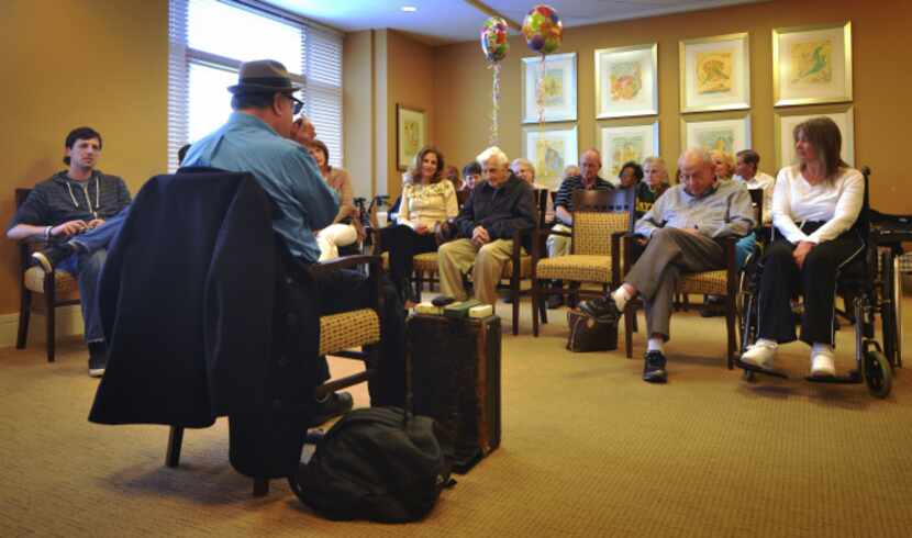 Vincent Van Buren plays harmonica to a full room at The Legacy at Willow Bend in Plano for...