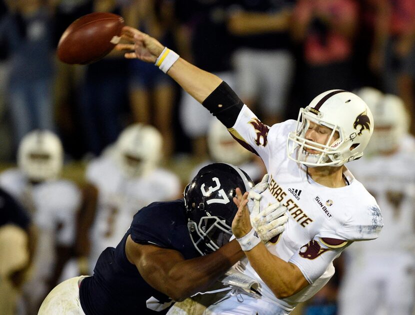 STATESBORO, GA - OCTOBER 29:  Quarterback Tyler Jones #2 of the Texas State Bobcats is hit...