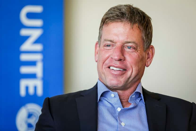 Troy Aikman smiles during an interview  about why he decided to  fold his nonprofit into the...