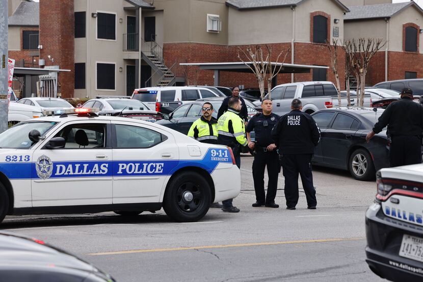A Dallas Police Department patrol car sits at the scene of a shooting involving an officer...