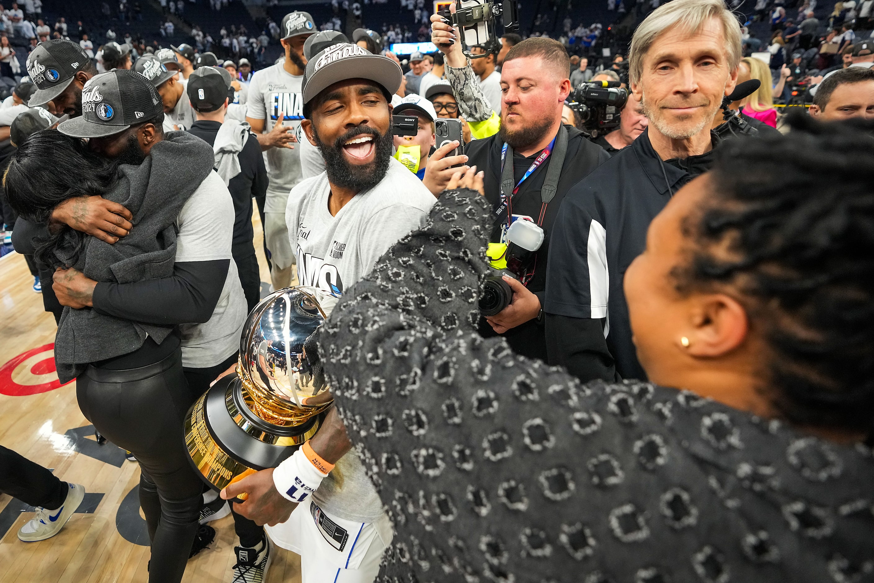 Dallas Mavericks guard Kyrie Irving celebrates with the trophy after a victory over the...