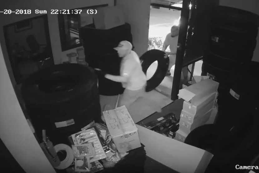 Two suspects were captured on security cameras removing large tires from an auto parts store...